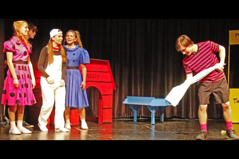 Linus (Tauren Jack) speaks lovingly to his blanket, as a group of girls watches him with amusement, in a scene from "You're A Good Man, Charlie Brown", a musical to be held Feb. 23-25 as a fundraiser, at Weyburn's T.C. Douglas Centre.