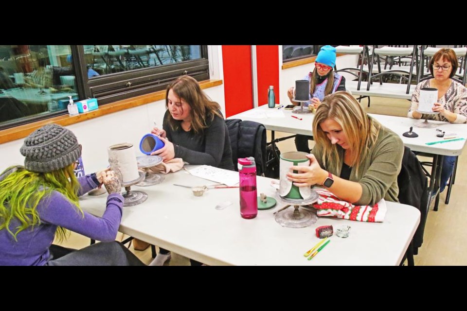 These women took part in a decorative clay jar class at the Spark Centre on Friday evening, including at left, Shelby Stadler, Shandi Van De Sype and Breanna Fradette, and at the back, Lorena Squires and Karen Ochitwa.