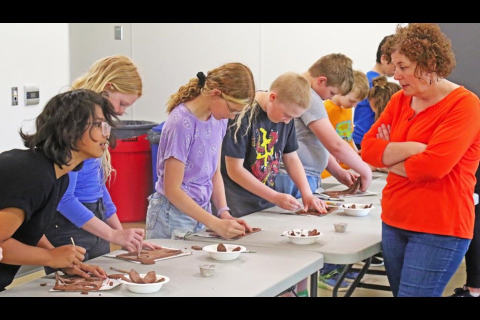 Grade 5 teacher Tammy Manning chatted with some of her students on Friday, taking the May clay class at the CU Spark Centre.