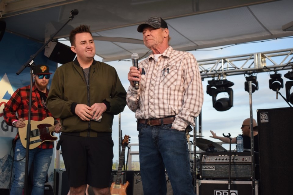 MC Robert Godfrey with Lemon Wedge Marketing listens while Bienfait Mayor Ken Bonokoski speaks. 