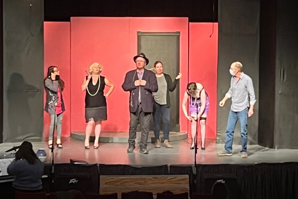 Ebeneezer Scrooge (played by Lane Easton), The Ghost of Jake Marley (Foster Warriner) and four 1920s-style Flapper Girls (Dianne Twietmeyer, Erica Armstong, Jessica Shirley and Megan McAuley) rehearse for the show.  