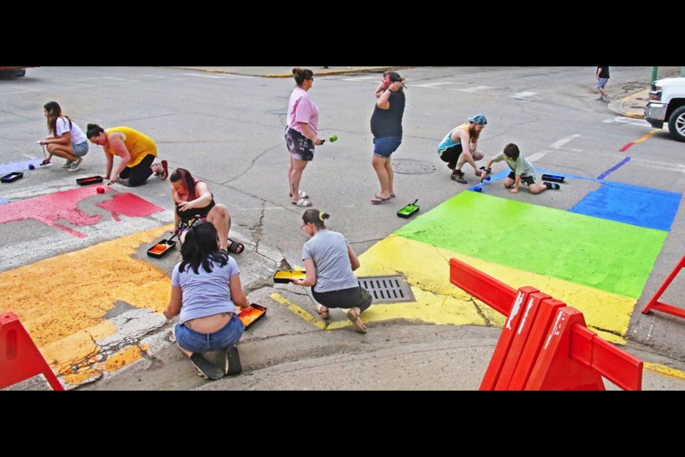Members of the Weyburn Arts Council, CUPE and the community were on hand to paint rainbow colours at an intersection in downtown Weyburn for Pride Week.