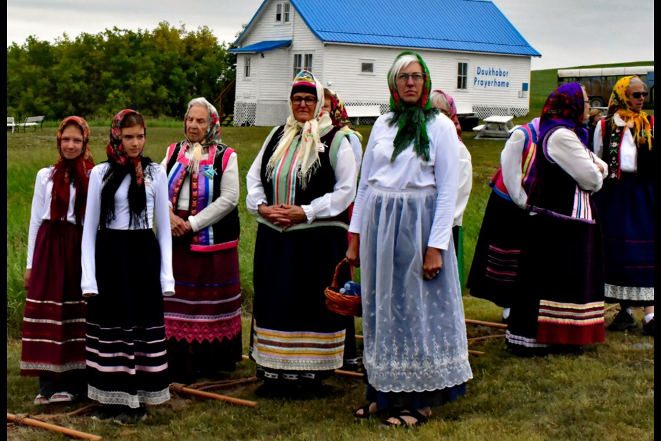 Descendants of the Doukhobor settlers wear their traditional dress as they line up to start the reenactment scene.