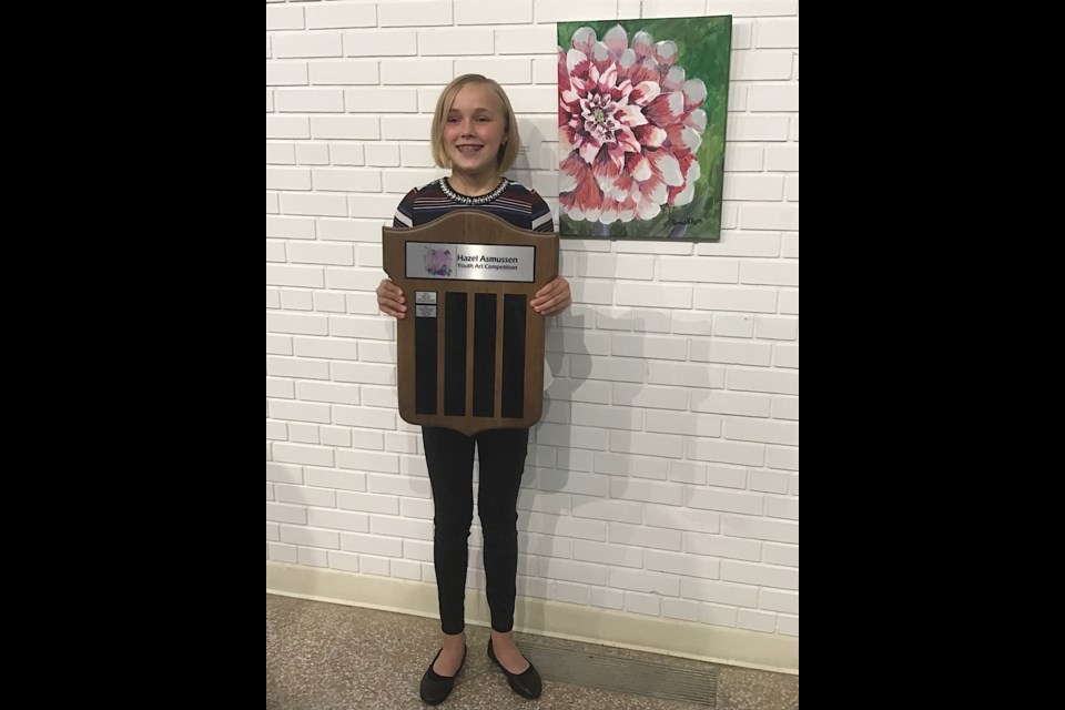 Hazee Award winner Brooklyn Hochbaum with the Hazee Award plaque.