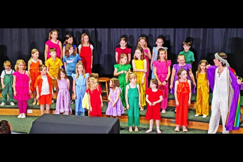 Joseph (Emerson Jack, at right) shows a group of children his coat of many colours, in a scene from "Joseph and the Amazing Technicolor Dreamcoat", to be staged at Grace United Church on May 9-12.