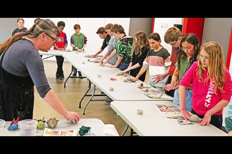 Instructor Regan Lanning led a group of Grade 6 students from Legacy Park school in the beginning stages of making their clay monsters on Friday