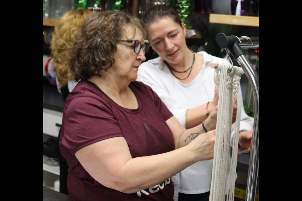 Instructor Candace Karkut, right, gives some advice to Sherry Shumay.