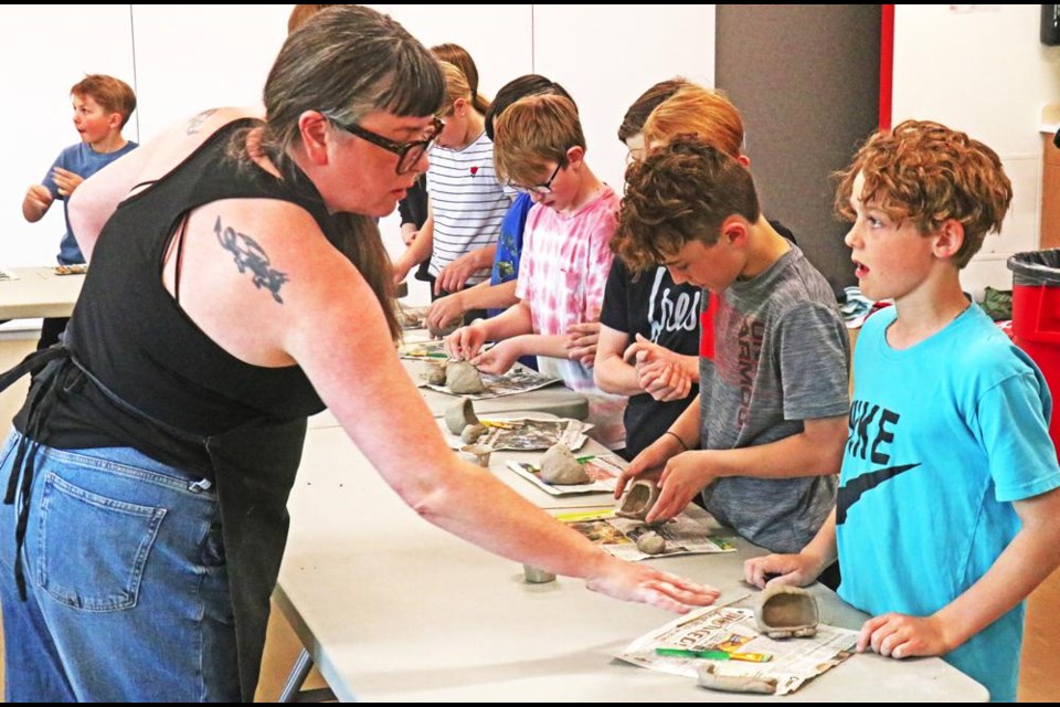 Clay instructor Regan Lanning gave step-by-step instructions to a Grade 5 class from St. Michael School as they made their pinch-pot clay monsters on Friday at the Credit Union Spark Centre