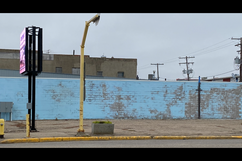 These photos show the progress of the mural from conception to final product.