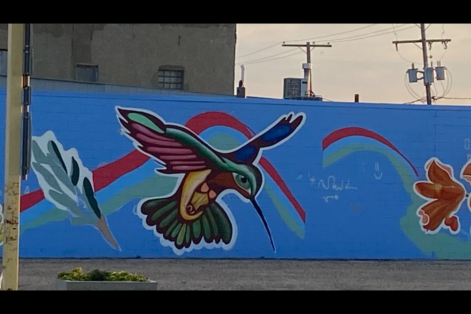 These photos show the progress of the mural from conception to final product.