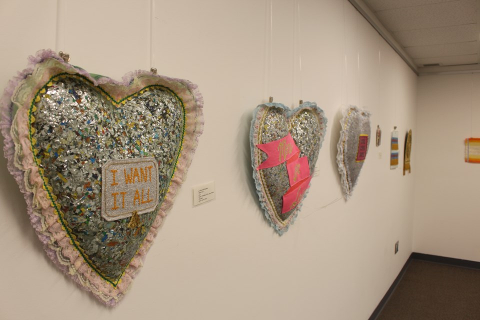 Richardson uses discarded chip bags to fill the pillows. The chips bags are washed and dried before being shredded to become stuffing for the art pieces.