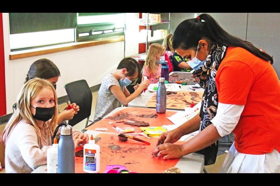 Art instructor Asmara Riaz helped out a student during the first full-day PD Day art camp on Friday at the CU Spark Centre.