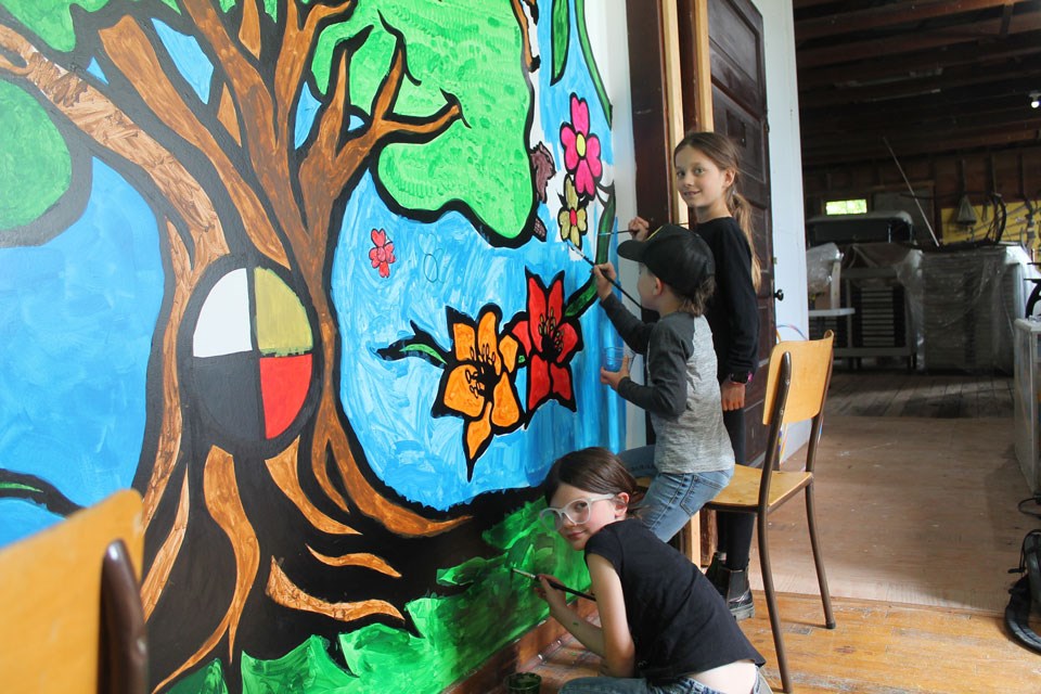 From left, Scarlett, Gord and Rosemarie Madsen working hard to help complete the mural. 
