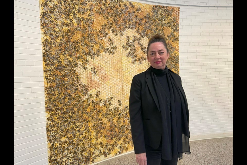 Artist and co-chair of SK Printmakers Monique Martin with her installation called Continuous.