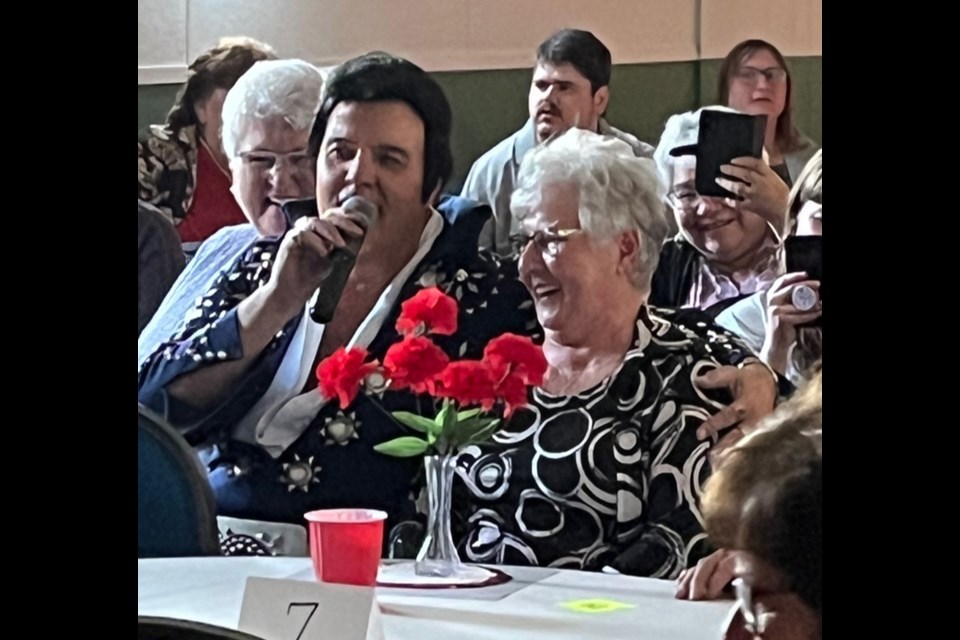 While mingling among the crowd, Elvis Impersonator Cadillac Kid sang to a pleasantly surprised Liz Barteski.