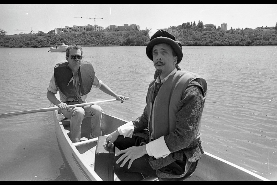Actor David Bearisto dressed as William Shakespeare, being rowed to his boat.