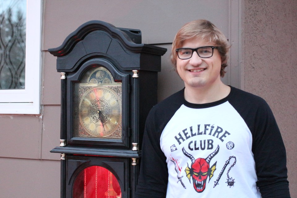 Kurt Karcha, pictured here sporting a Hellfire Club t-shirt (a fictional board game club from the show) and standing next to a grandfather clock reminiscent of one used in 'Stranger Things 4'.  The clock was programmed to chime every ten minutes and play Kate Bush's 'Running Up That Hill', an 80's song that saw a re-emergence on account of the show's popularity.