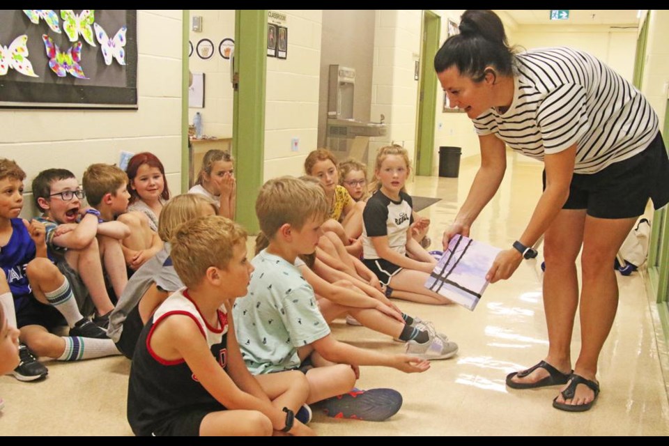 Weyburn artist Tana Cugnet showed students a closeup view of the original painting that they had done impressions of in class at APES recently.