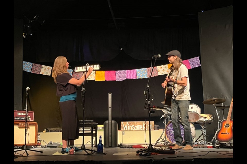 Leora Joy with her melodica and husband Scott with his guitar as they bring their music to the Carlyle Community Theatre. 