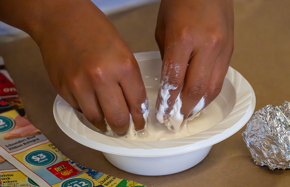 Spencer Stebanuk mixes the glue and water together.