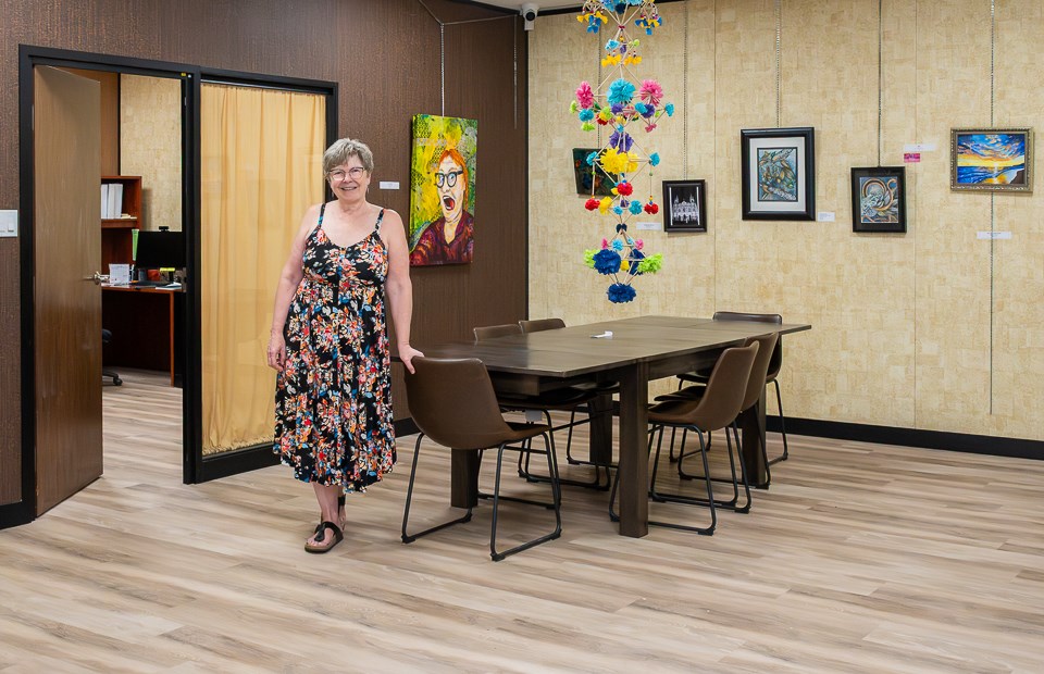 Linda Coe Kirkham stands in the meeting area of the Concern for Youth.