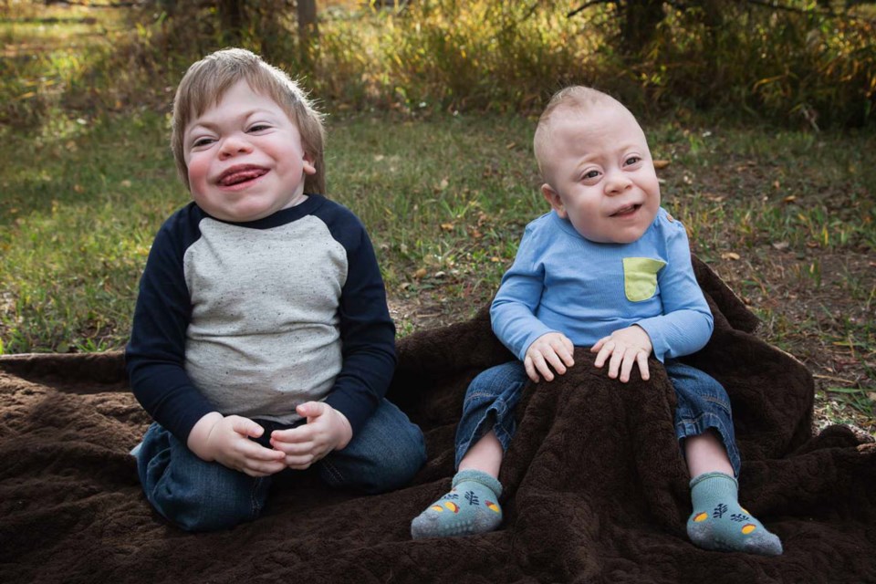 Joshua and Declan Graham, both diagnosed with I-Cell disease, pose for the camera during family photos.