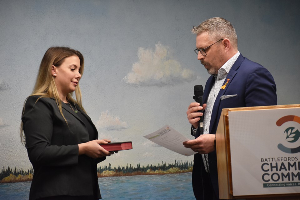 Mayor Ames Leslie administers the  oath of office to Glenda Rye.