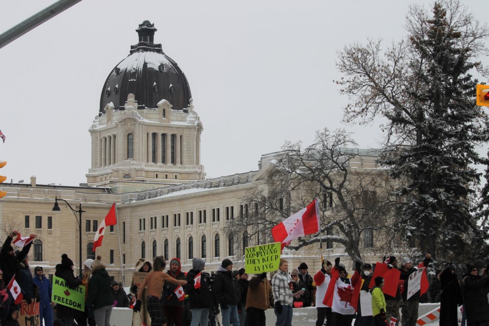 A large group of people gathered at the entrance to the Legislative Assembly in Regina awaiting the convoy's arrival.