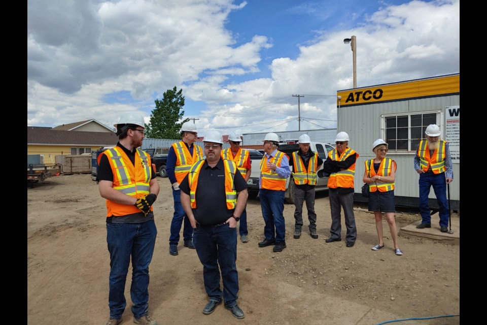 Members gather for a tour of the construction site