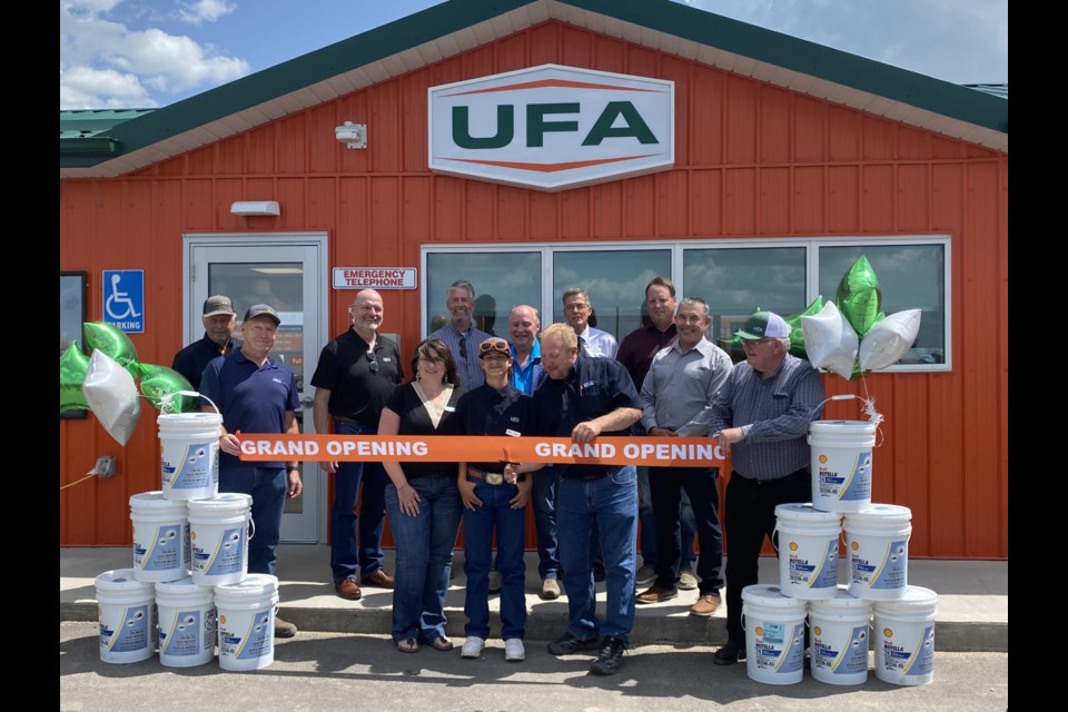 Weyburn UFA Petroleum agents  Laura Lee and Jason Petersen, and their son Korbyn, cut the ribbon during the grand opening.
