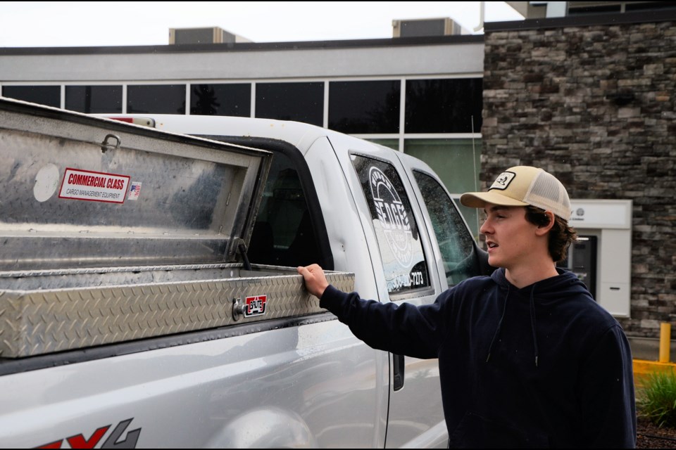 Left, Edge Window Washing owner Bronson Volk explains how he runs water through an extra filter, mounted on his truck, to ensure a streak- and spot-free finish. Right, Unity Chamber of Commerce new business welcoming committee members Gerald Hauta and Kelsey Sperle take a closer look at the water filter.