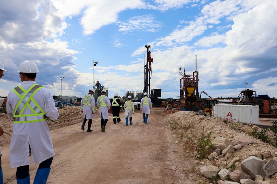 Members of the ministry and mining company touring the McLean Lake site.