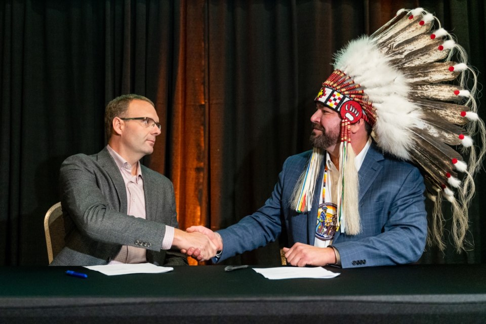 Signing the agreement to launch Beaver River Broadband were John Degrauuw, president and CEO, Wood River Controls and Tribal Chief Richard Ben, MLTC. 