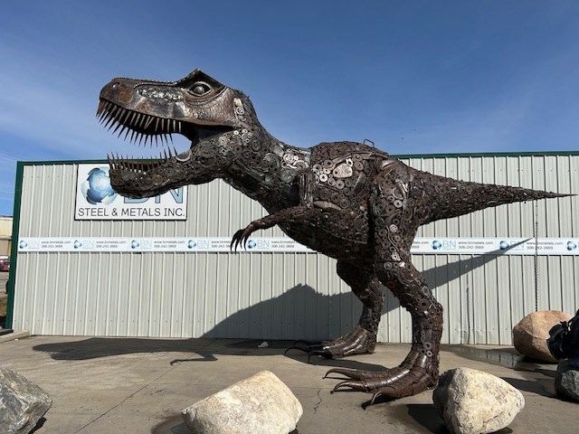 A 15 foot T-Rex sculpture stands guard at Saskatoon's BN Metals, as the business held a special Earth Day event.