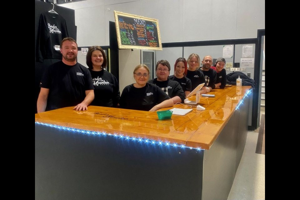 The friendly staff who are part of the grand opening of Border Mountain House at Madge Lake include, from left: Jared Ruf and Nicky Ruf, (owners), Deloris Cockerill, Virginia Antony, Becky Martin, Regan Nichol, Joe Vivian, and Sasha Garcia.