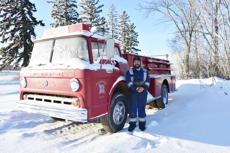 Colin Bullock of Bullock Mechanical in Hyas stands alongside a decommissioned firetruck that he purchased from the Town of Hyas. With a new decal on its door representing his business, the vintage vehicle has been showcased at community events and car shows in the surrounding area. 