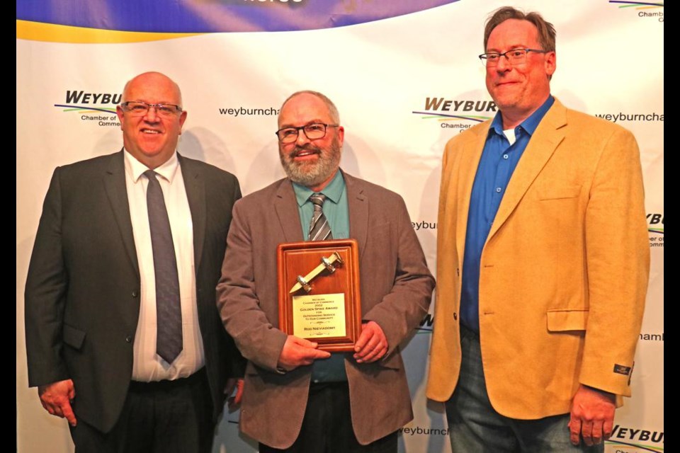 Rod Nieviadomy, centre, was named the 2022 winner of the Golden Spike Award; he is flanked by Larry Heggs, manager of the Weyburn Chamber of Commerce (left) and Ron Irvine of Access Communications, the sponsor of the annual award