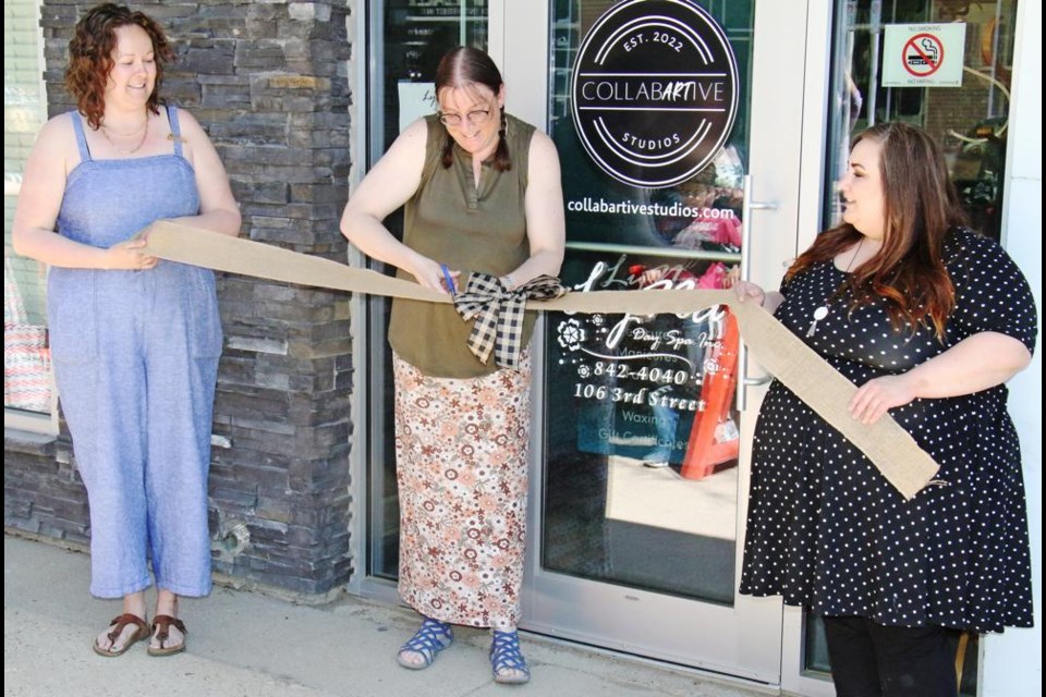 Coun. Laura Morrissette had the honour of cutting the ribbon as Collabartive Studio partners Krystal Glowatski, left and Malia Brackpool held the ribbon on Saturday