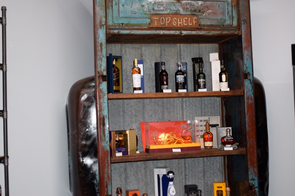 The top shelf of the new Local Buzz Liquor Store has some of the pricier items. 