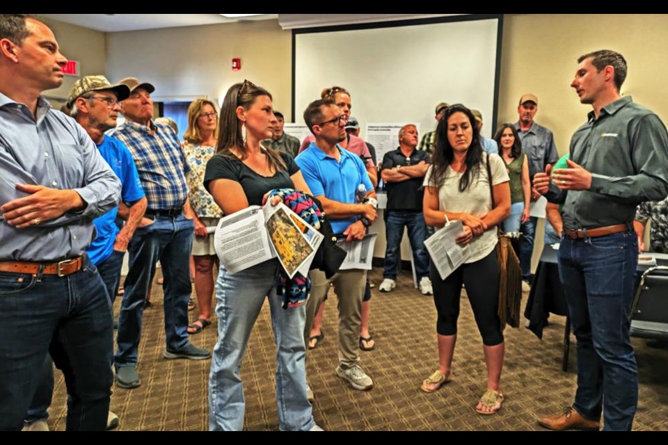 Keith Taylor, right, a specialist for renewable products, power business development, for Enbridge, fielded most of the comments and questions from RM area residents at the open house on July 17.