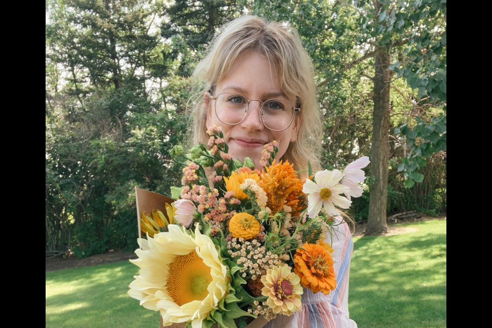Alesha Boettcher with one of her flower arrangements. 