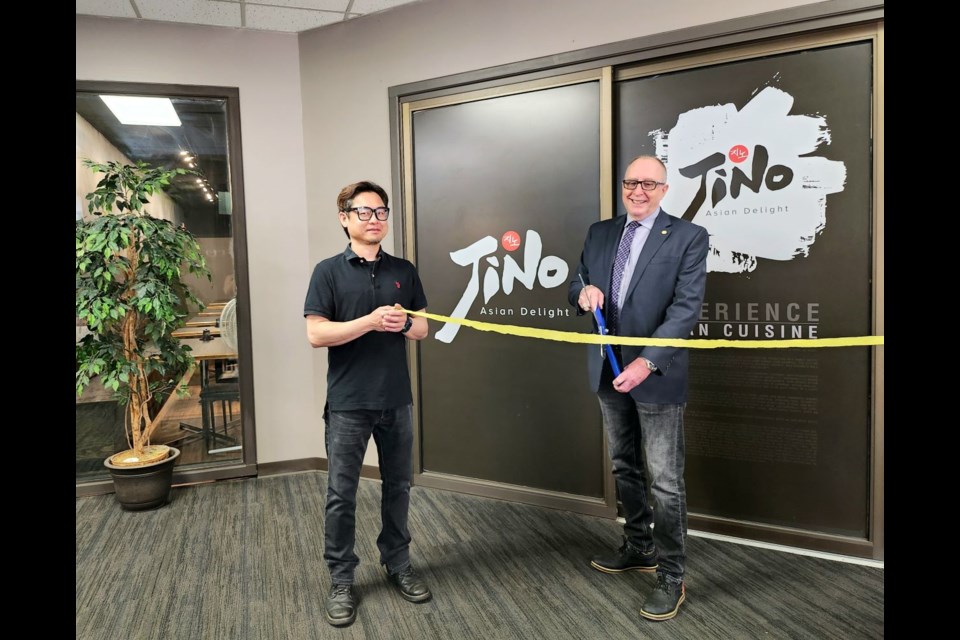 Jino Kim, owner of Jino's Asian Delight in Estevan, and Mayor Roy Ludwig cut a ribbon to reopen the restaurant after renovations.