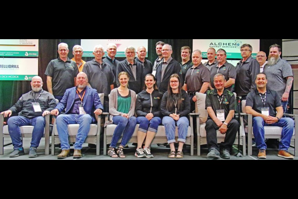 The board of the Sask. Oil and Gas Show gathered onstage after the final presentation. In the back row from left are Mayor Marcel Roy, Mark Schneider, Darren Woodard, Ryan Janke, Dylan Gilliss, Richard Henning and Larry Heggs. In the middle are Darcy Cretin, Tim Bangsund, Trevor Pandachuk, Ken Ferguson, Bill Pittman, Trevor Sealy, Pat Maloney and Todd Bedore. In front are past chair Del Mondor, show chair Dan Cugnet, Tonya Miller, show manager Monica Osborn, Reece Pittman, Don Sealy and vice-chair Shane Pollock. Missing was Nikki Dickie.