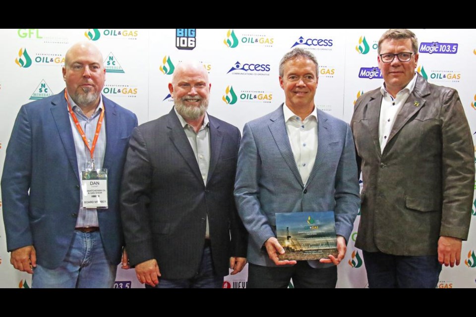 Oil Show chair Dan Cugnet and Board of Governors rep Del Mondor gathered with Hall of Fame inductee Reg Greenslade, after the presentation of the award by Premier Scott Moe, at right