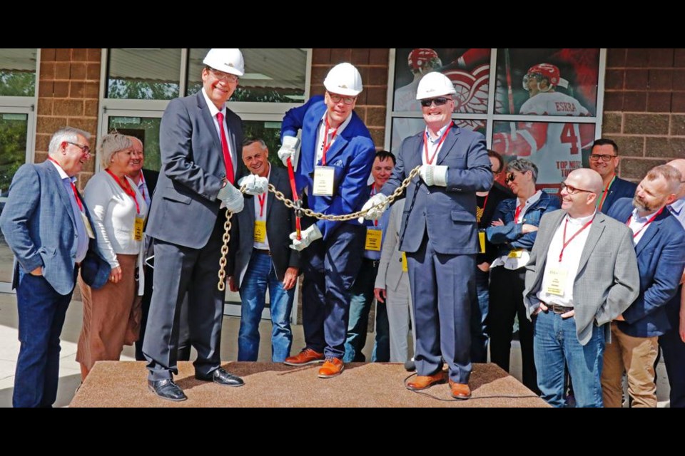 Mayor Marcel Roy and Premier Scott Moe, along with Oil Show chair Del Mondor, opened the 2019 Oil Show with the official chain-cutting ceremony; surrounding the podium in this photo are the members of the provincial cabinet, as they were present to see the show and to have a cabinet meeting while in Weyburn