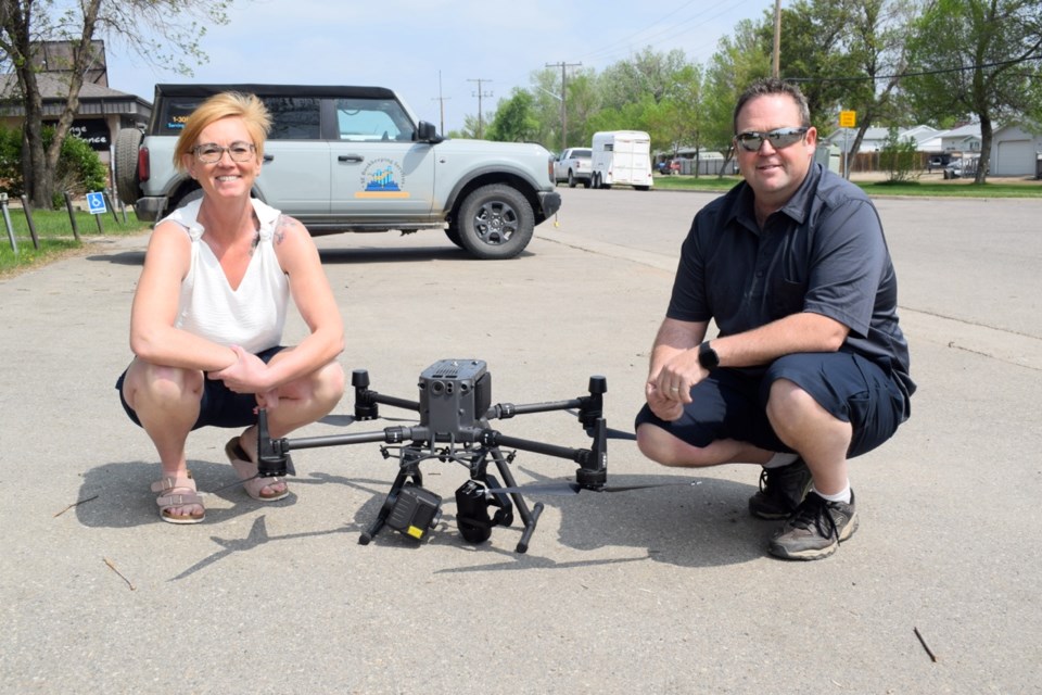 Brandy and Rod Cullen with the drone that is used for Rod Cullen's business, Predator Inspections Ltd.