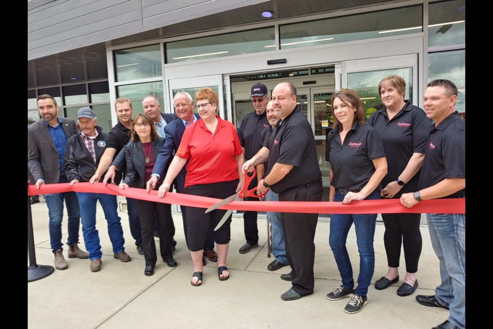 Dignitaries helped cut the ribbon during the grand opening of the Southland Co-op Centre held September 17. From left are MP Jeremy Patzer, Arnold Montgomery, Trenton Karst, Chris Saintclaire, Pat Piche, MLA David Marit, Mayor Sharon Schauenberg, Gerald Muldoon, Dale Lessmeister, Curtis Nelson, Hali Booth, Kim Eklund and Mike Krauss.