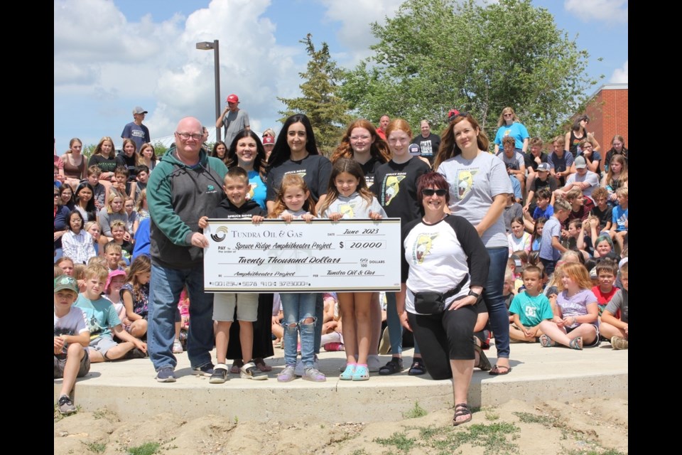 Participating in the donation presentation were, from left, Craig Lane, vice-president of production operations with Tundra Oil and Gas; Loni Hollingshead, vice-principal; Marja Stang, SCC chairperson; students Kaitlyn Stepp and Danika Ross; and SCC member Carolyn Murphy. Front row, students Bentley, Kacee and Bailey Stang and principal Cheri Haberstock. 
