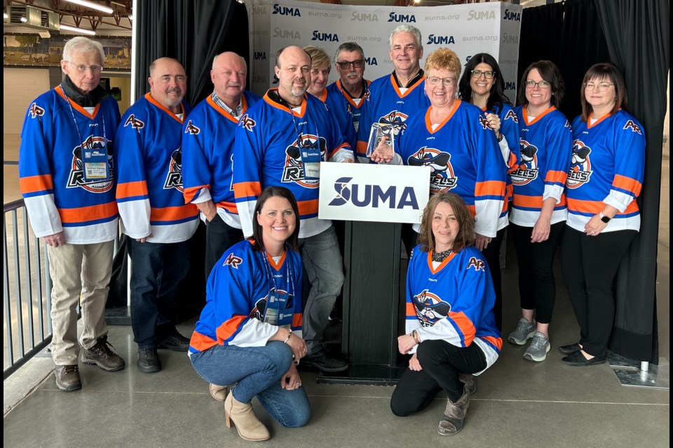 Representatives from the Town of Assiniboia who attended the Saskatchewan Urban Muncipalties Association (SUMA) convention wore Rebels jerseys. In the back row, from left are, Coun. Graham Harvey; Dale Lessmeister, Civic Improvement Association; Clint Mauthe, CAO Town of Assiniboia; Curtis Nelson - president of the Civic Improvement Association; Kim Eckland - Civic Improvement Association; Coun. Robert Ellert, Coun. Patrick Grondin, Mayor Sharon Schauenberg, Kerri Martin, Tina Dijkstra and Coun. Rene Clermont. In the front row, from left, are  Stephanie VanDeSype, Recreation and Community Wellness manager; and Hali Booth - Civic Improvement Association.