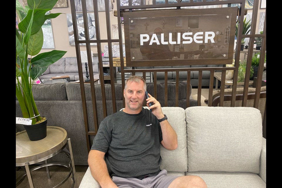 Owner Murray Aulie showing some of his inventory for Palliser Furniture.